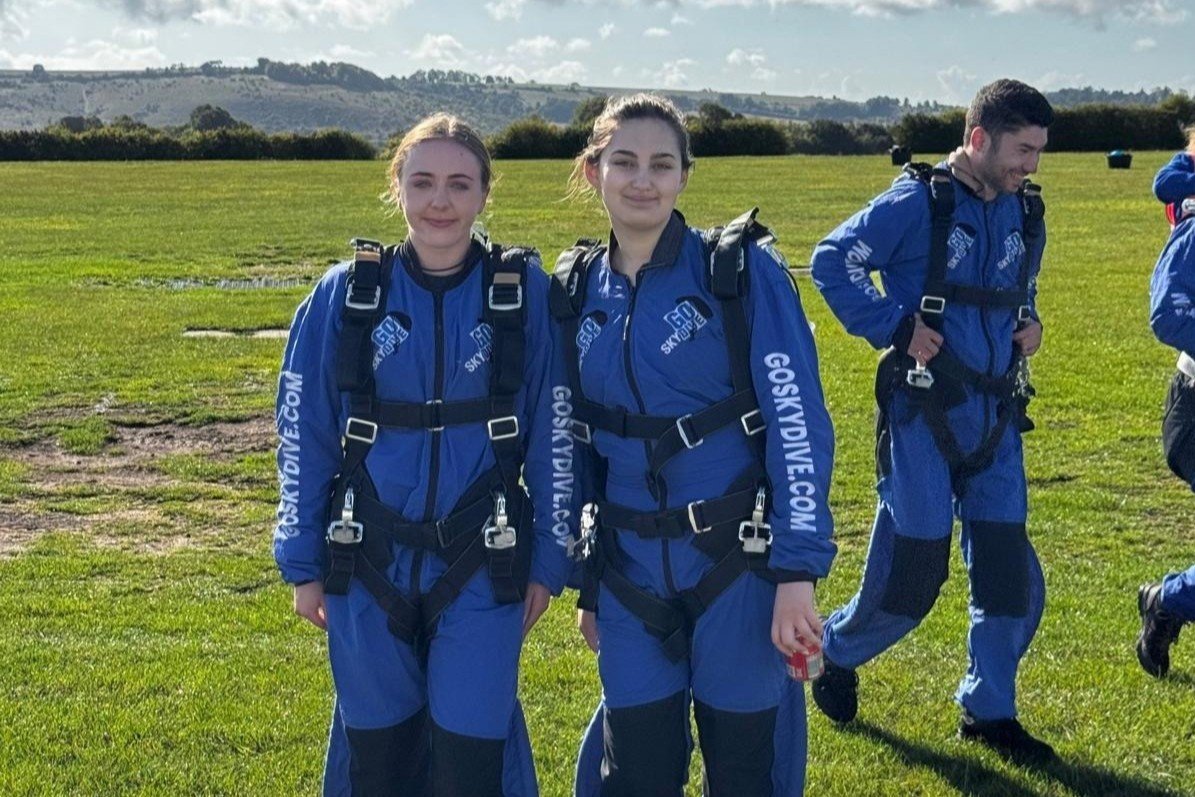 Emma and Mia smile to camera after their skydive