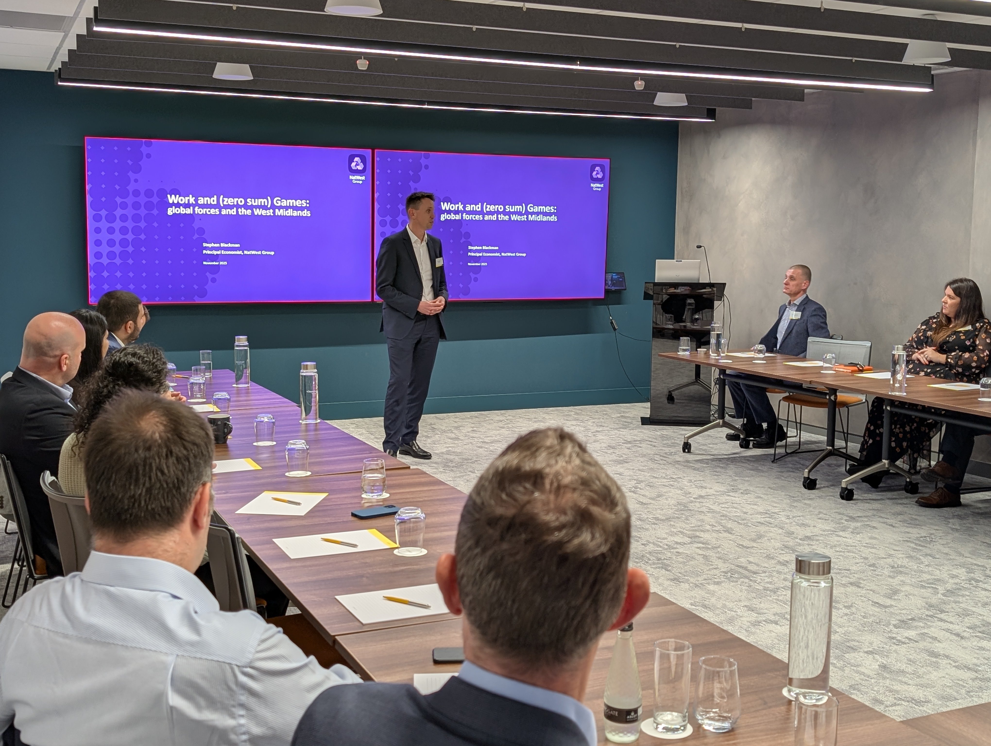 One of the event speakers addresses the boardroom of attendees