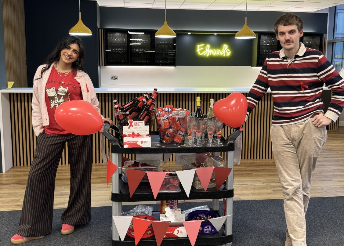 Two members from our marketing team smile with the decorated trolley