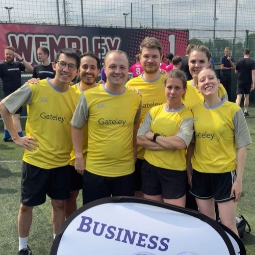 Team smile to camera wearing yellow Gateley football tees