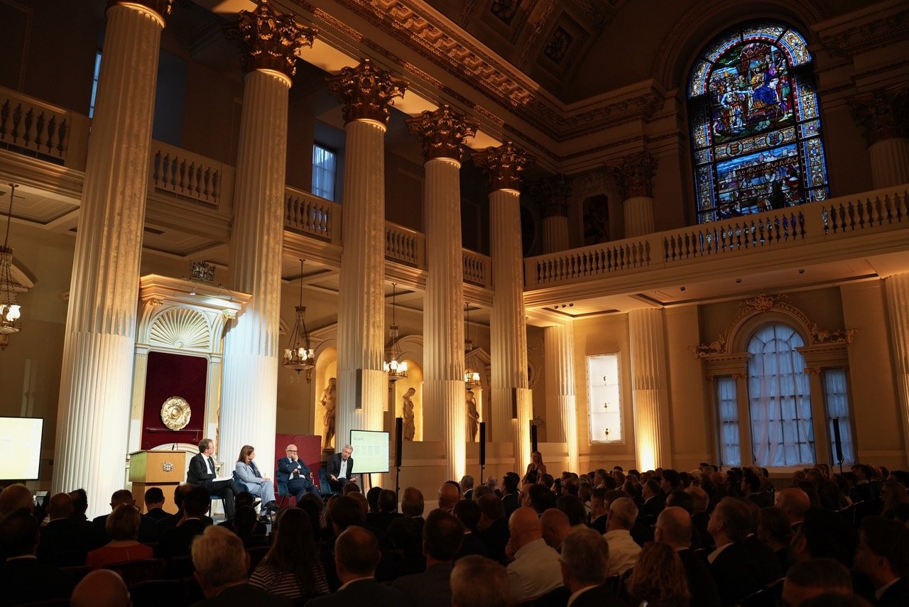 Wide shot of event while panel speaks