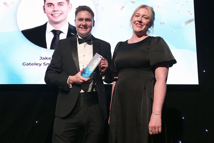 Photo of Mark Campbell receiving award on behalf of Jake