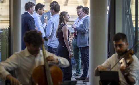 Guests mingling with live music and drinks