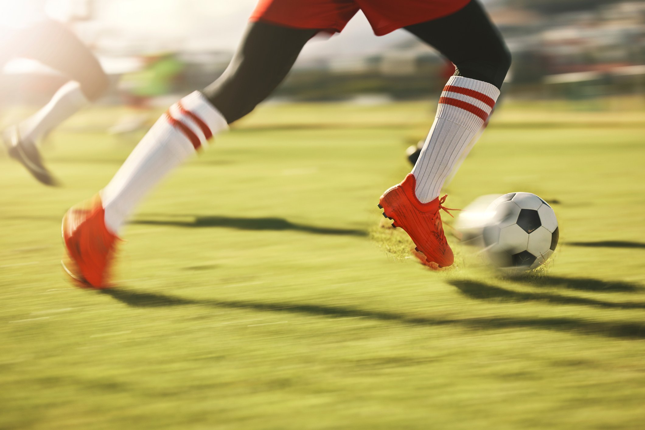 Image of football player kicking ball
