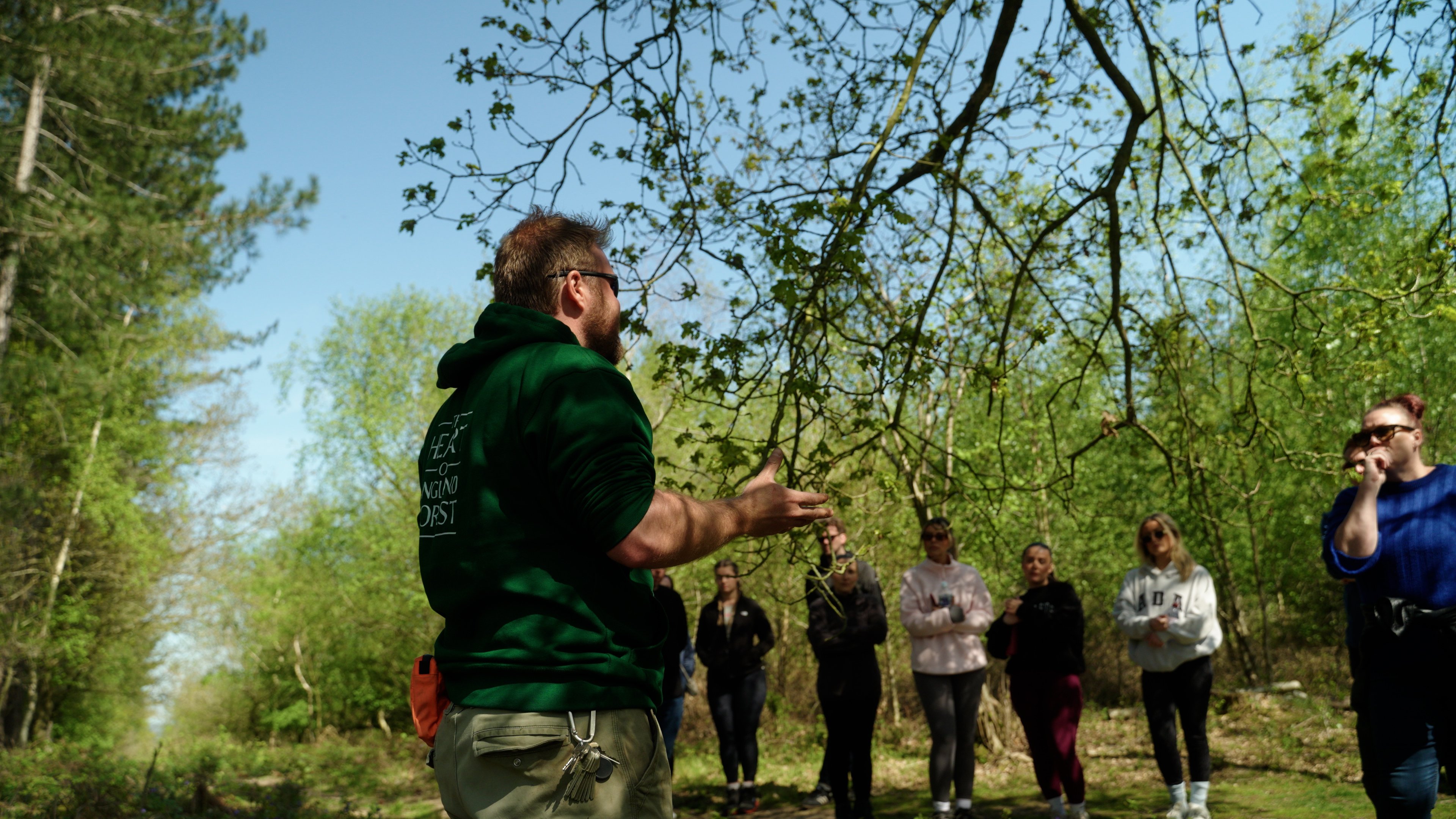 The team listening a talk from a Heart of England Forest worker