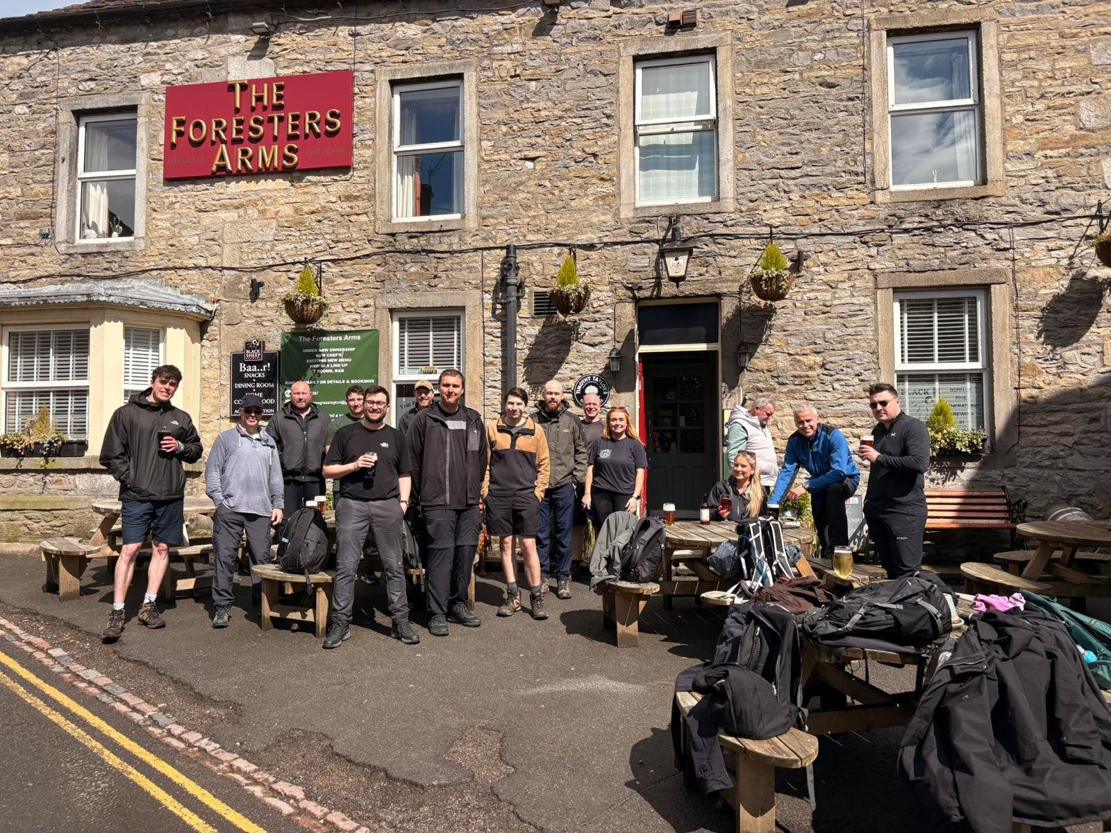 Our team celebating their walk outside a pub in the sunshine